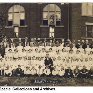 Turners men, women, and children singing group outside South Side Turnverein.